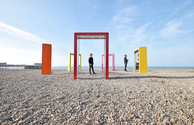 Mirrored beach huts and doorways on Worthing beach