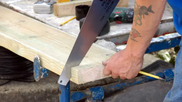 man does some sawing of wood