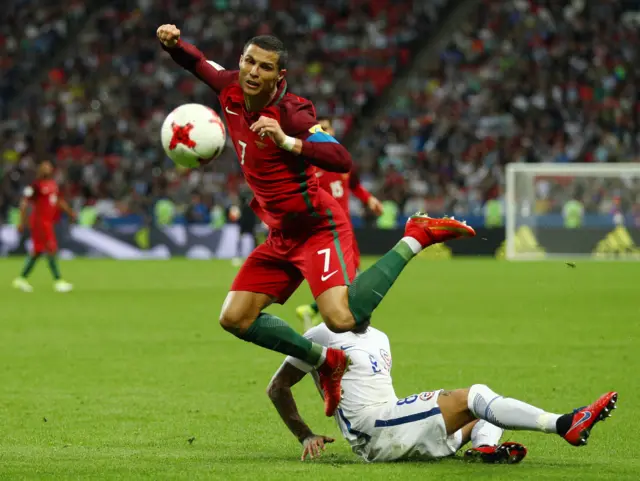 Cristiano Ronaldo of Portugal is fouled by Arturo Vidal