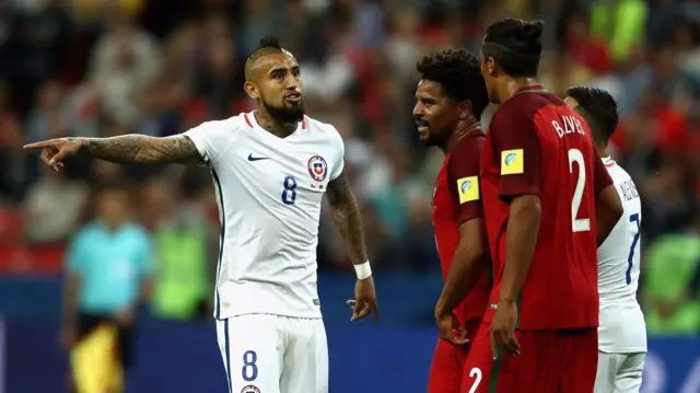 Arturo Vidal of Chile argues with Bruno Alves