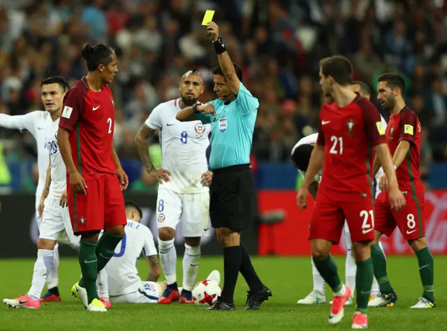 Bruno Alves of Portugal is shown a yellow card