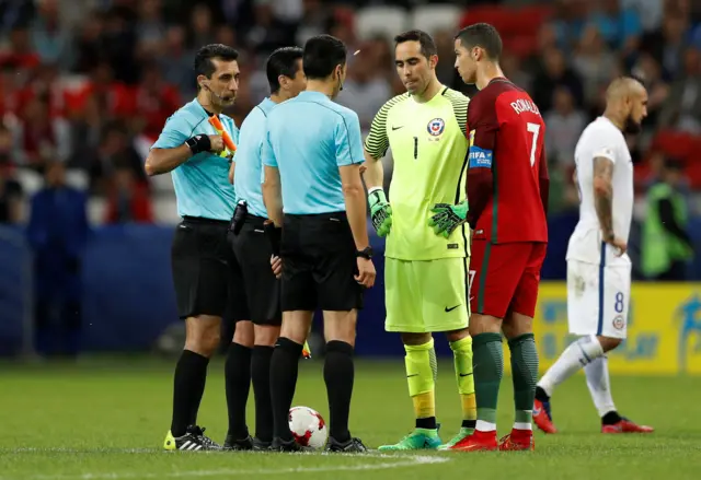 Cristiano Ronaldo and Claudio Bravo talk to referee