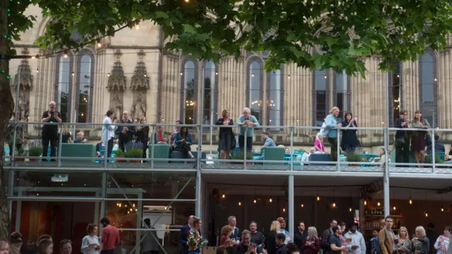 People socialising outside Manchester Albert Square