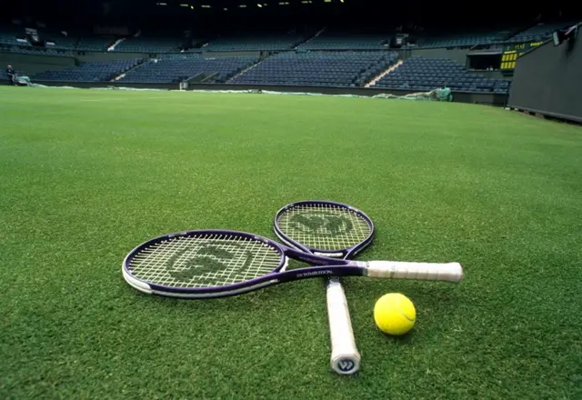 Tennis rackets and a tennis ball on the court at Wimbledon