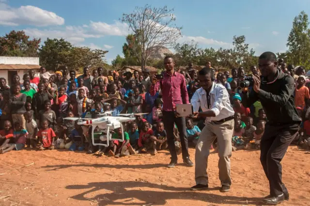 People look on during a drone safety and awareness demonstration on June 22, 2017, in regards to humanitarian drone corridor testing under the UNICEF-funded Humanitarian Drone Corridor testing project,