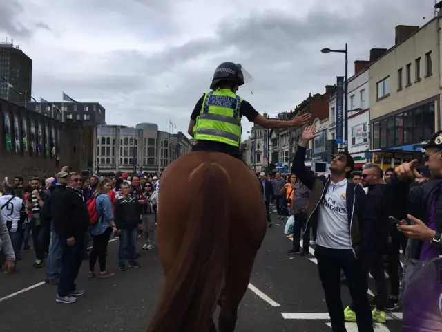 mounted police officer greets a fan