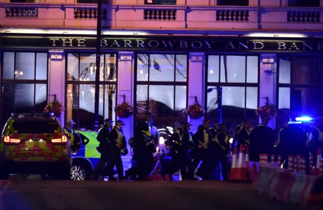 Police officers outside the Barrowboy and Banker Public House on Borough High Street