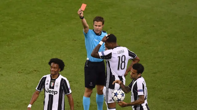 Juan Cuadrado of Juventus is shown a red card