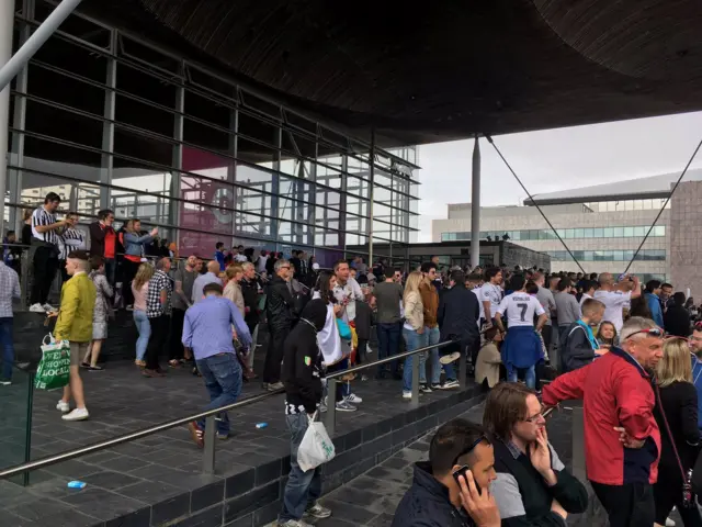 Fans take shelter at the Senedd