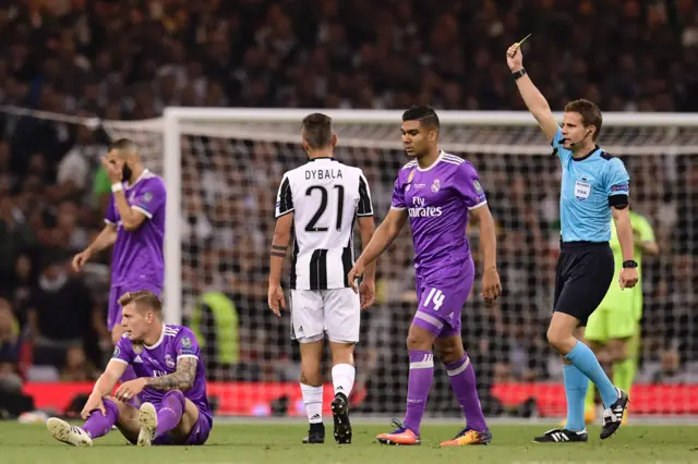 Paulo Dybala is shown a yellow card