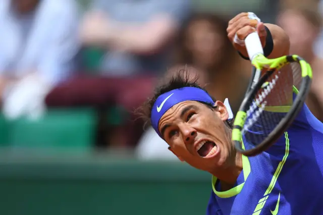 Rafael Nadal serves