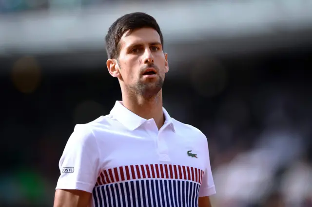 Novak Djokovic looks on