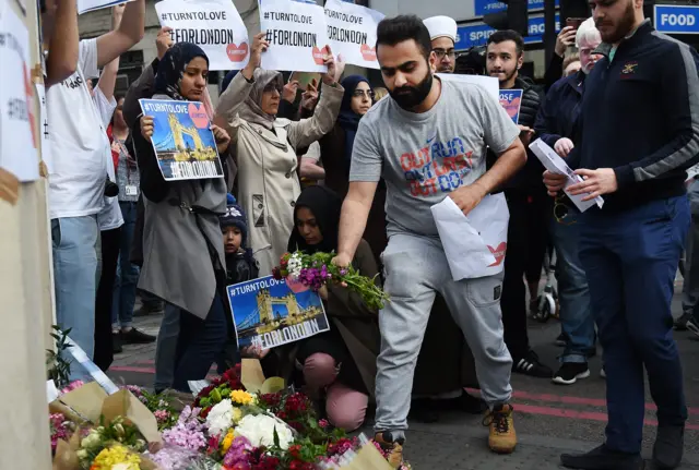 Members of the Muslim community laying flowers