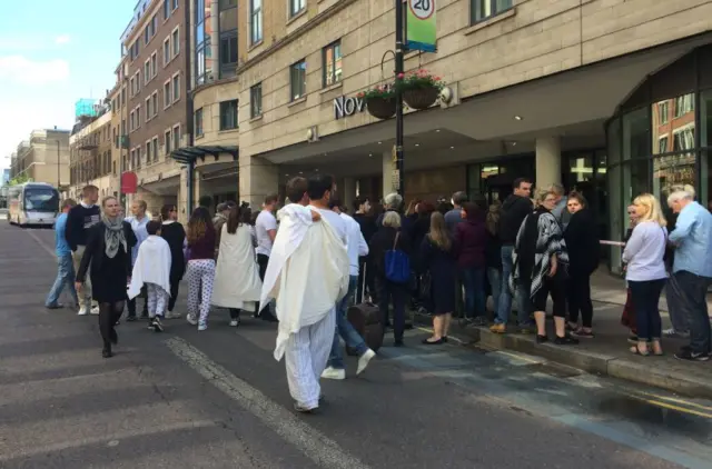 People queuing outside hotel