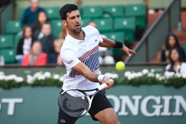 Novak Djokovic returns