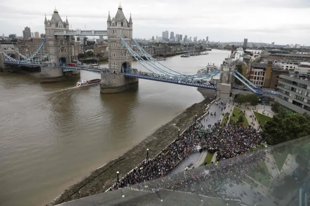 Tower Bridge is seen spanning the River Thames as people gather at Potters Fields Park in London on June 5, 2017