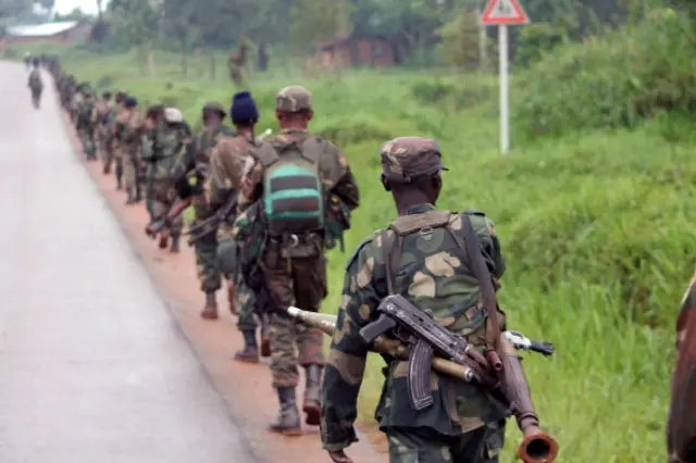 Democratic Republic of Congo (FARDC) soldiers march on December 31, 2013 towards the front line in Eringeti to fight against the Allied Democratic Forces and the National Army for the Liberation of Uganda (ADF-Nalu), a rebel group opposed to the Ugandan government.