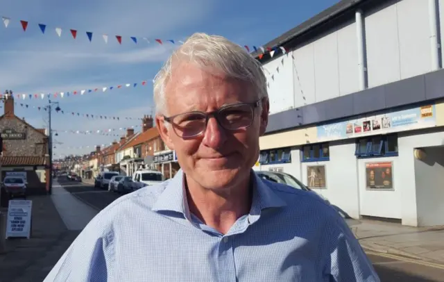 Norman Lamb standing in Sheringham town centre