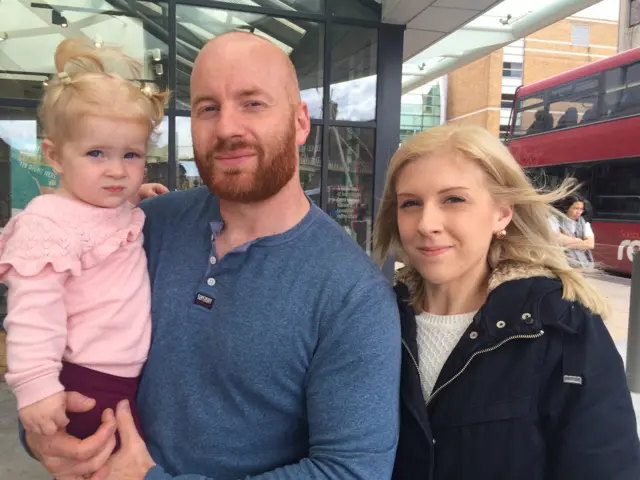 Emma Sibley, 27, and Karl Hucker, 32, alongside their young daughter.