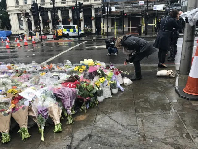 Woman lays flowers down at London Bridge for the victims