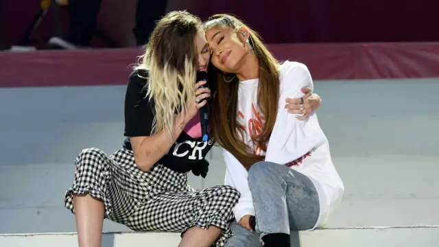 Miley Cyrus and Ariana Grande (r)