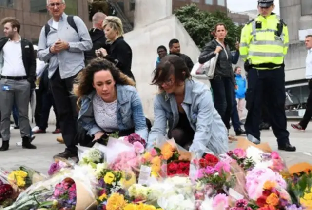 People leaving floral tributes to the victims of the London terror attack