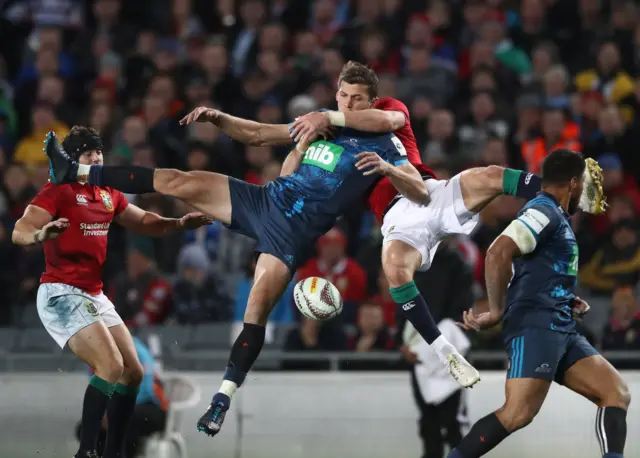 Matt Duffie of the Blues is tackled in the air by Liam Williams