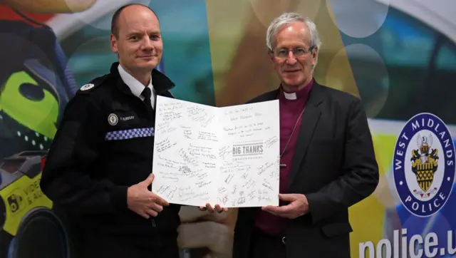 The Bishop of Birmingham delivering the card to West Midlands Police