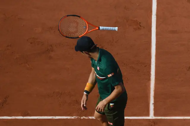 Kei Nishikori throws his racket