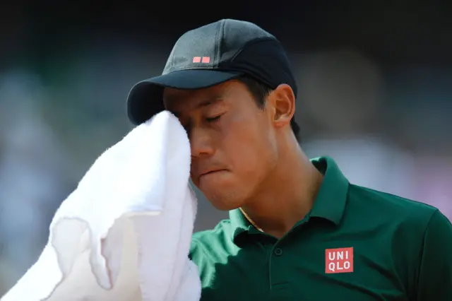 Kei Nishikori wipes his face