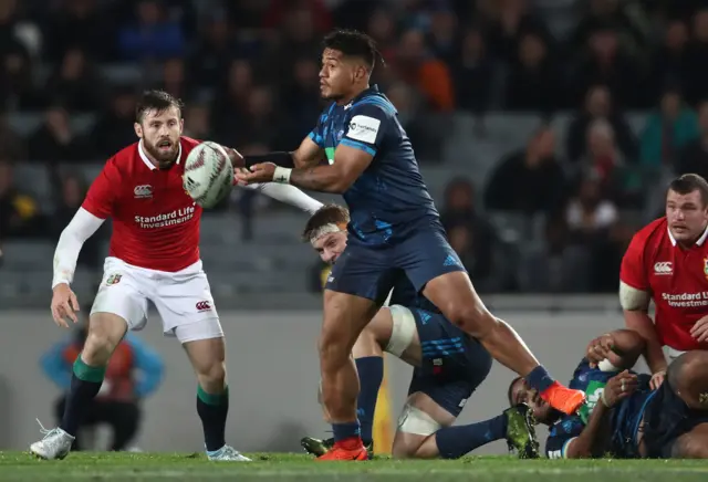 Augustine Pulu of the blues passes the ball