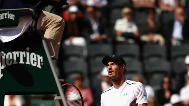 Andy Murray of Great Britain questions a decision