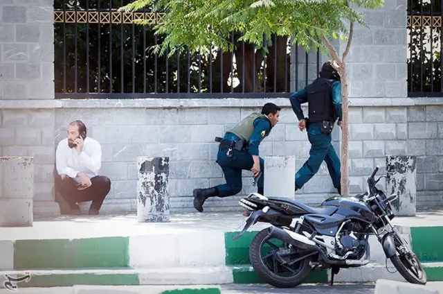 Members of Iranian forces run during an attack on the Iranian parliament in central Tehran, Iran, 7 June 2017.