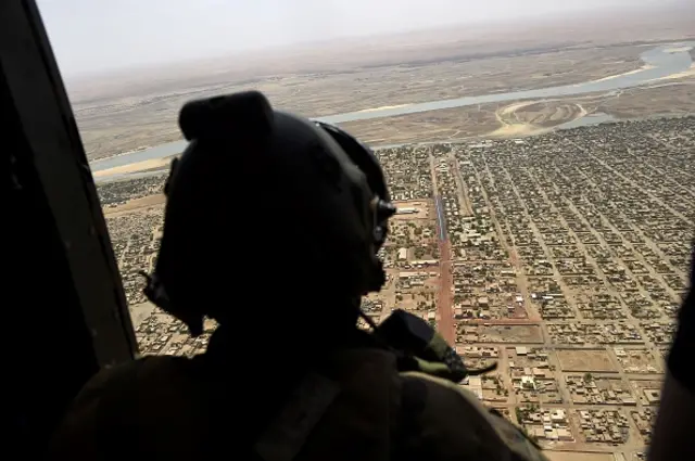 A French soldier stands inside a military helicopter during a visit by French President to France's Barkhane counter-terrorism operation in Africa's Sahel region in Gao, northern Mali, on May 19, 2017