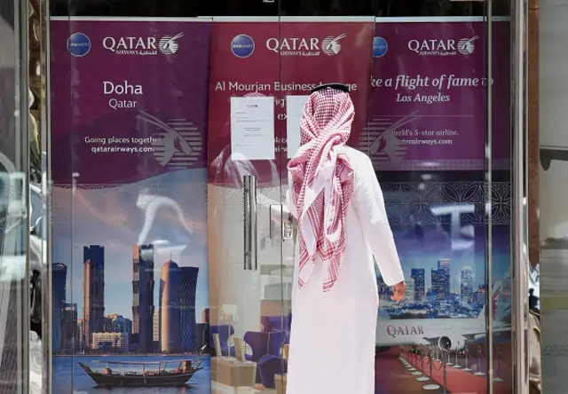 A picture taken on June 5, 2017 shows a man standing outside the Qatar Airways branch in the Saudi capital Riyadh, after it had suspended all flights to Saudi Arabia following a severing of relations between major gulf states and gas-rich Qatar.