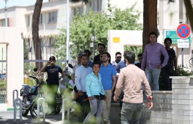 People gather near the parliament's building during a gunmen attack in central Tehran, Iran, on 7 June 2017. T