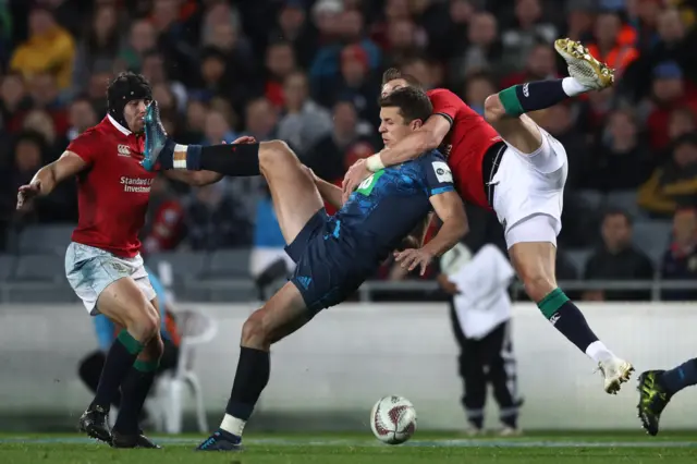 Matt Duffie of the Blues is tackled in the air by Liam Williams