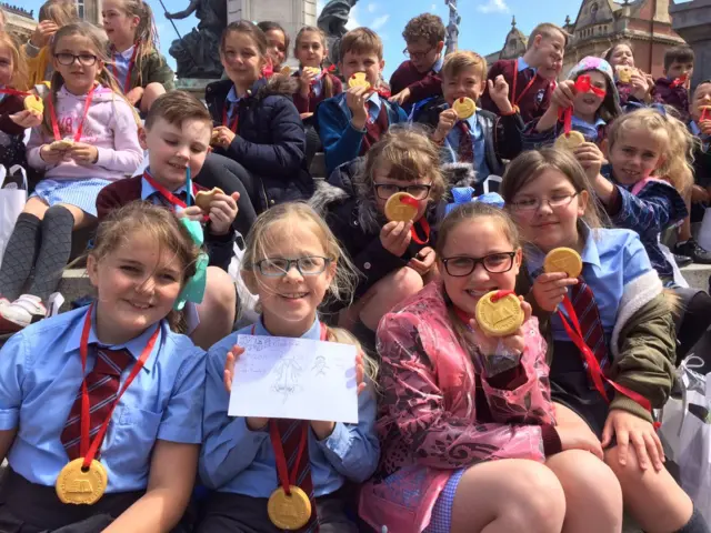 Children with biscuit medals