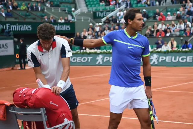 Rafael Nadal comforts Pablo Carreno Busta