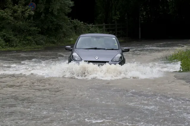 Car drives through deep water