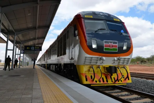 One of Kenya"s newly acquired standard gauge rail locomotive, carrying Kenyan President pulls into Voi railway station on May 31, 2017 in Voi, during an inaugural ride on Kenya"s new standard gauge railway from the coastal city of Mombasa to the capital, Nairobi