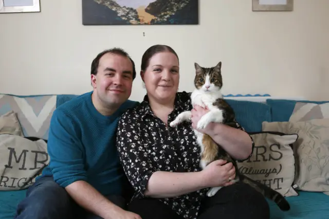 Kirsty Furness and her partner Alex from Stevenage with their pet cat Charlie