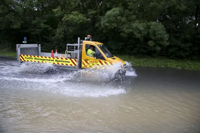 Traffic management vehicle tyre-deep driving through flood