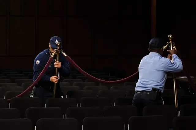 Workers preparing the hearing room