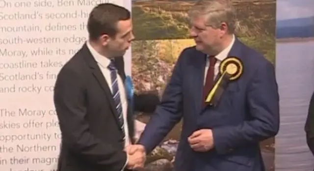 Douglas Ross is congratulated by Angus Robertson