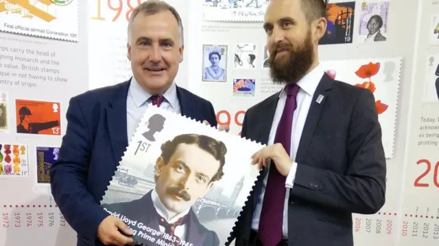 Mark Williams, holding a stamp featuring former prime minister Lloyd George, has lost his seat