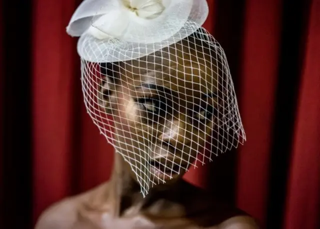 Models waits backstage to enter the catwalk at the Africa Fashion Week in Lagos on June 3, 2017.