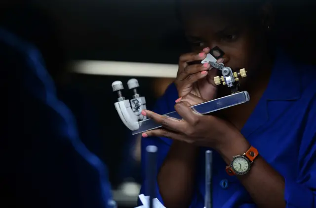 An employee of the Blue Star diamond company cuts and polishes diamonds in Gaborone office in Botswana on October 4, 2016