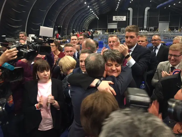 Arlene Foster congratulates party colleague Nigel Dodds with a hug