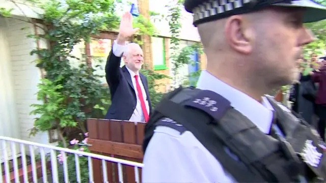 Jeremy Corbyn waves at bystanders